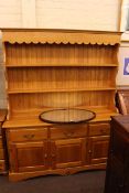 Pine three door shelf back dresser and oval oak framed bevelled wall mirror