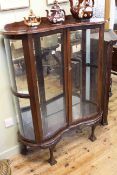 Walnut shaped front two door china cabinet on ball and claw legs