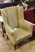 Late Victorian wing back armchair on turned legs