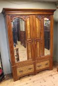 Victorian carved walnut wardrobe having two mirror doors above two drawers