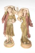 Pair Royal Dux figures of a female water carrier and male with basket and fruit,