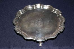 Edwardian silver salver with Chippendale border and on three feet, London 1907,