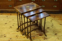 Painted yew and rosewood nest of three spider leg tables