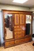 Victorian walnut combination wardrobe having two central carved panel doors above five drawers