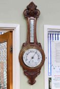 Carved oak aneroid barometer-thermometer