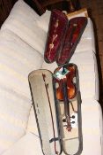 Two cased violins and bows