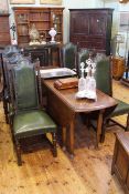 Large oak drop leaf dining table on pad feet together with a set of six oak and studded hide dining