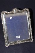 Large Edwardian silver easel photograph frame with gadroon and scroll border,