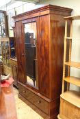 Victorian mahogany wardrobe having central mirror door above a long drawer on plinth base