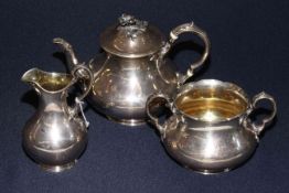 Victorian silver three piece tea set by Barnards, the baluster bodies with relief leaf decorations,