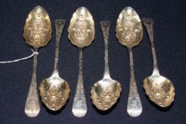Set of six George III silver berry spoons, with embossed bowls and chased handles,