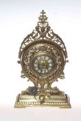 Ornate brass mantel clock with enamelled numerals