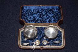 Cased pair of Victorian silver open salts and spoons, in aesthetic taste,