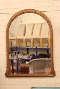 Arched top bevelled framed wall mirror