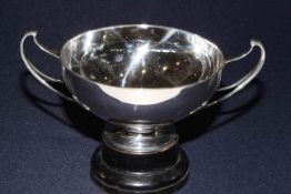 Silver two handled bowl and stand, the plain shallow body with upswept handles,