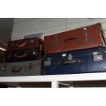 Five assorted vintage suitcases