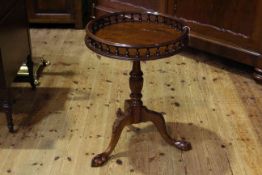 Circular mahogany tripod table with spindled gallery,