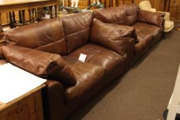 Pair of brown distressed leather settees,