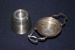 Silver tea strainer and mounted match striker (2)