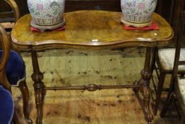 Victorian figured walnut shaped top side table raised on turned pillars to four scrolled legs,