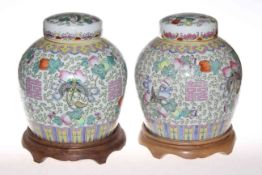 Pair Chinese polychrome ginger jars and covers, with wood stands,