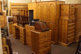 Collection of ten pieces of pine bedroom furniture comprising triple and double wardrobes,