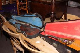 Two cased violins and cased mandolin