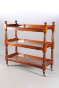 AN EARLY VICTORIAN MAHOGANY THREE TIER BUFFET, with reeded finials and supports, moving on castors.