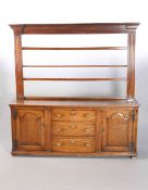 A GEORGE III OAK DRESSER AND RACK, the rack with fluted pilasters,