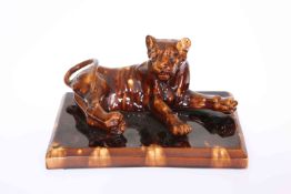 A GOOD TREACLE GLAZED MODEL OF A LIONESS, 19TH CENTURY,