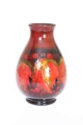 WILLIAM MOORCROFT A FLAMBE LEAF AND BERRY VASE, CIRCA 1930'S, of baluster form,