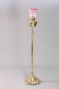 A HANDSOME EDWARDIAN POLISHED BRASS STANDARD LAMP, with reeded stem and circular base,