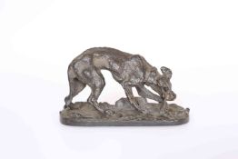 A BRONZE OF A DOG CHEWING ON A BONE, bears signature in the cast P.J. MENE.