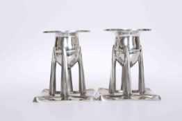 ARCHIBALD KNOX FOR LIBERTY & CO A PAIR OF TUDRIC PEWTER CANDLESTICKS, number 0222,