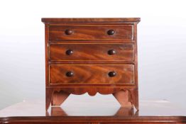 A 19TH CENTURY MAHOGANY MINIATURE CHEST OF DRAWERS, with three long drawers,