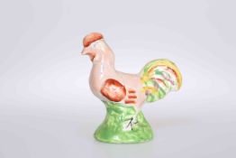 AN EARLY 19TH CENTURY STAFFORDSHIRE MODEL OF A COCKEREL,