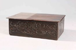 A 17TH CENTURY CARVED OAK BIBLE BOX, the front carved with scrolling foliage.