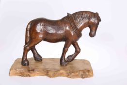 A CARVED OAK MODEL OF A HEAVY HORSE, carved wearing collar, now on a burr wood base.