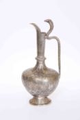 A 19TH CENTURY INDIAN MOORISH STYLE METAL EWER, profusely decorated with floral design and figures,