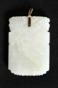 A CHINESE CARVED JADE PENDANT, rectangular, decorated to one side with a river landscape,