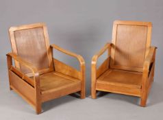 A PAIR OF HEALS MODERNIST OAK BOOK CHAIRS, CIRCA 1920'S, with pockets to each side for magazines,