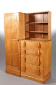 TO A DESIGN BY PETER WAALS A COTSWOLD SCHOOL OAK COMBINATION WARDROBE, combining a wardrobe,
