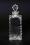 A GEORGIAN GLASS DECANTER, square section with slice cut decoration to the corners,