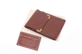 A CARTIER LEATHER AIDE-MÉMOIRE, boxed with suede cloth and card of authenticity.