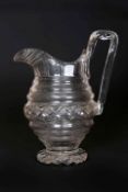 A REGENCY CUT-GLASS TABLE JUG, with hobnail cut band and strap handle.