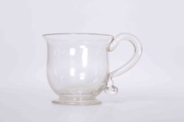 A GLASS CUSTARD CUP, with S-scroll handle.