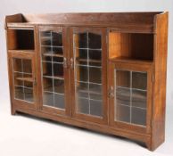 LIBERTY & CO AN ARTS AND CRAFTS OAK BOOKCASE, CIRCA 1900,