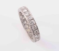 A DIAMOND ETERNITY RING, set to the entirety with twenty-two brilliant cut diamonds. Ring size J½.