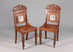 A PAIR OF VICTORIAN MAHOGANY HALL CHAIRS WITH INSET TILES BY JOHN MOYR SMITH,