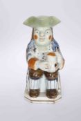 A PRATT TYPE POTTERY TOBY JUG, CIRCA 1790, of traditional form, seated holding a jug of ale.